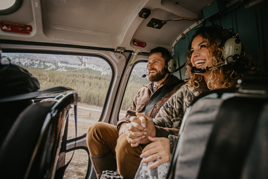 A happy bride and groom photo inside a helicopter during their helicopter elopement