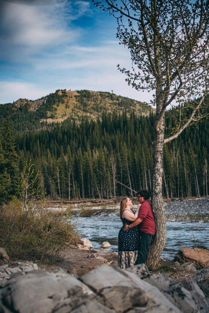 A romantic outdoors engagement photo by the lake