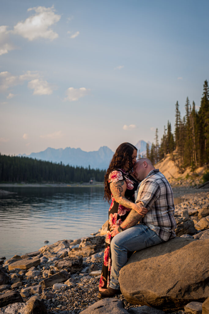 A romantic outdoors engagement photo by the lake