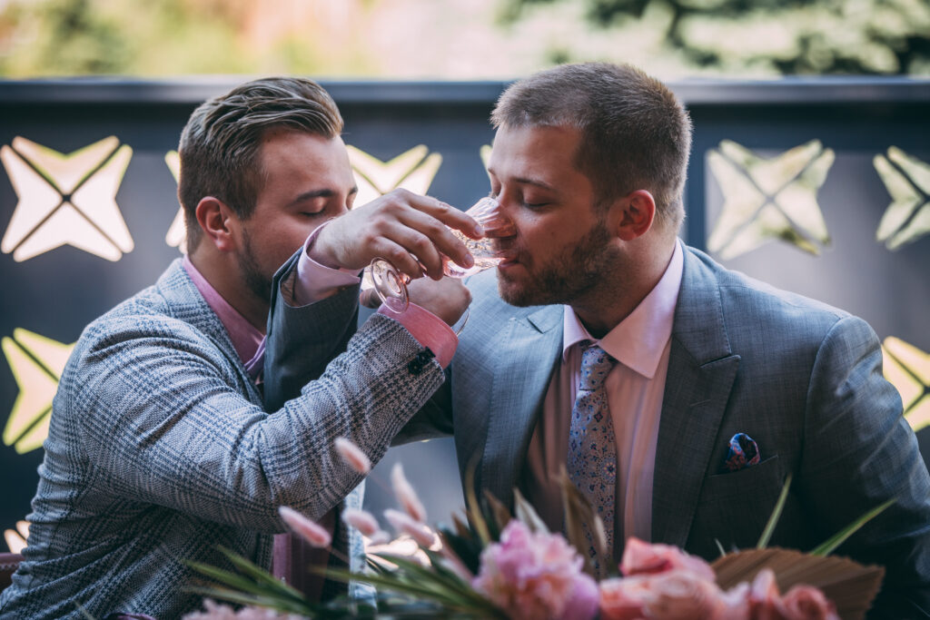 couple sharing drinks during wedding first looks
