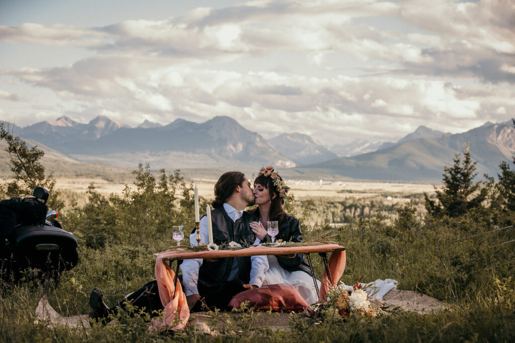 Bride and groom Alberta elopement picnic with champagne