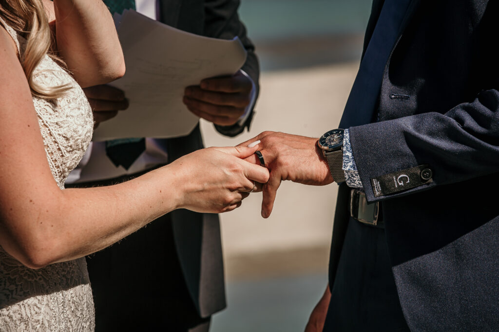 Bride and groom exchanging rings during their Alberta elopement