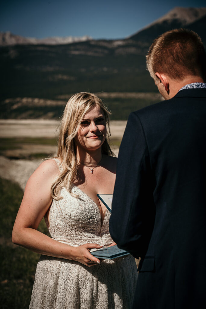 Bride and groom exchanging vows during their Alberta elopement