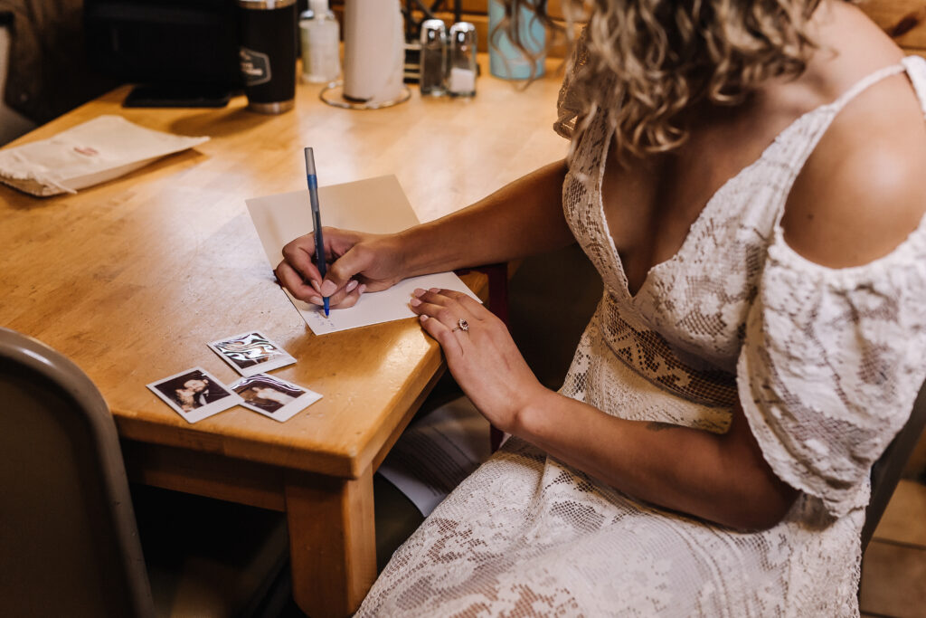 Bride writing letter during their Alberta Elopement