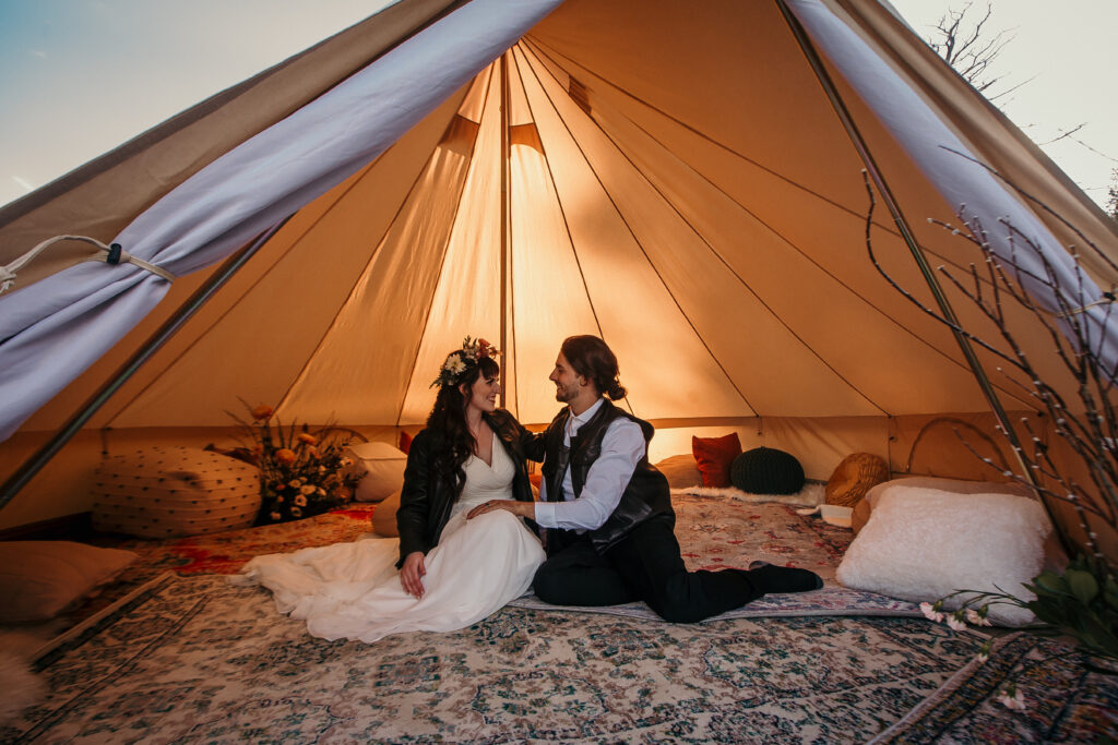 Bride and groom outdoor elopement in tent