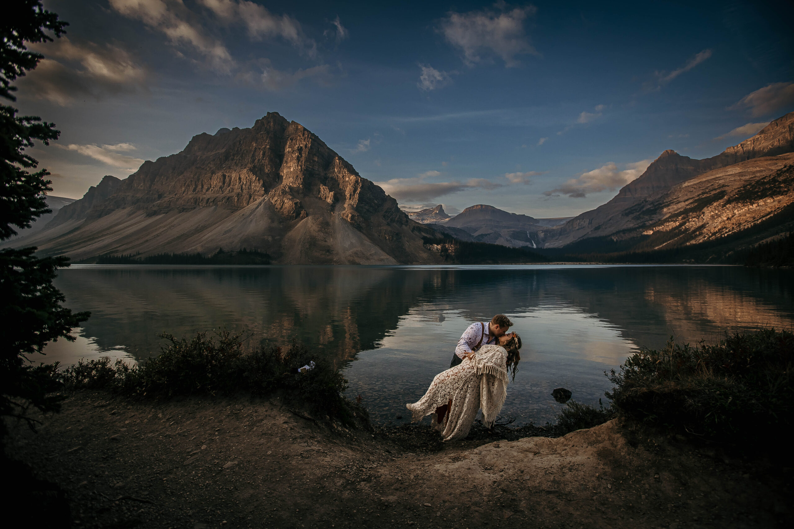 Couple eloping in the Canadian Rockies surrounded by mountains and alpine lakes, showcasing the best elopement locations in Alberta.