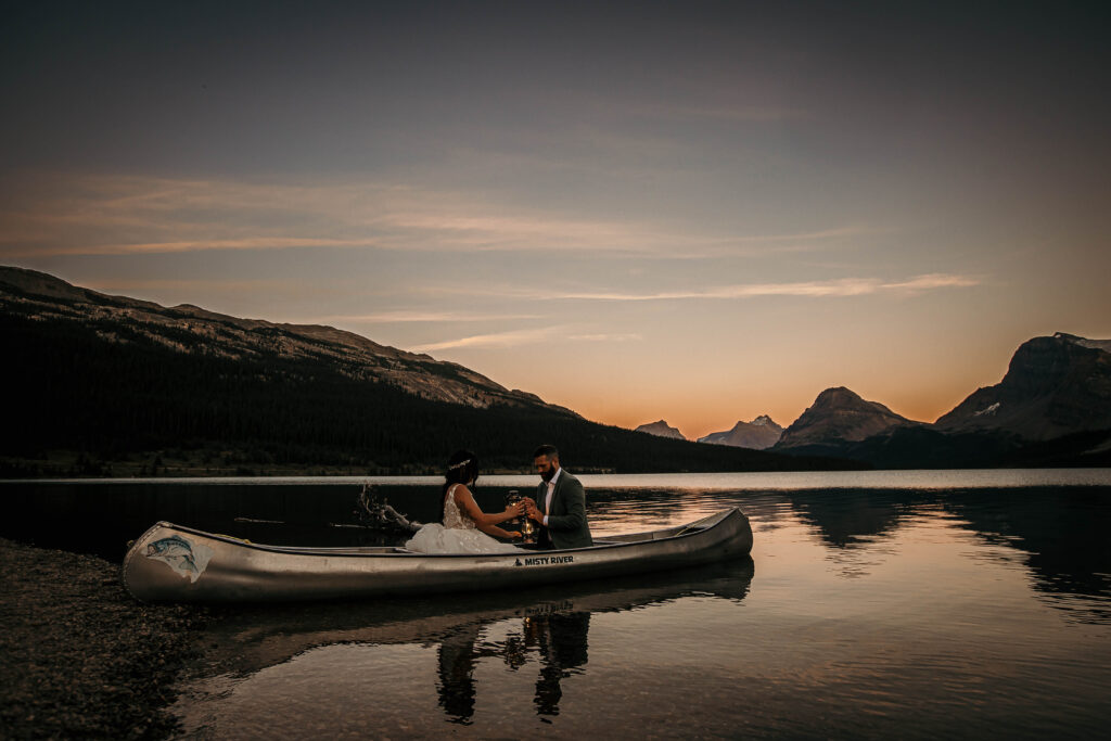 Couple eloping at Bow Lake with turquoise water and surrounding peaks along the Icefields Parkway.
