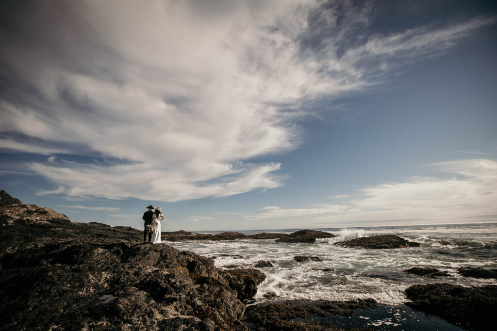 Couple on a cliffside overlooking the Pacific Ocean during their Ucluelet elopement.